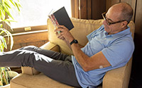 grandpa_on_chair_reading_book_200x125