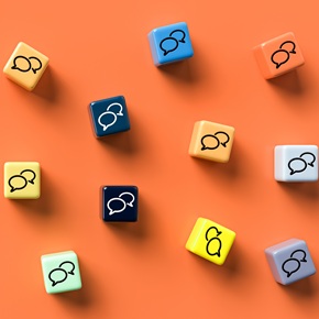 many cubes with speech bubble icons on orange background