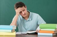 Man With Books At Desk
