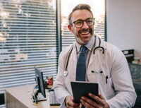 Doctor with digital tablet in his office