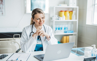 Doctor meeting remotely with her patient
