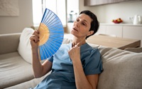 Tired stressed woman fanning home sweating hard no conditioning suffocating difficulty breathe